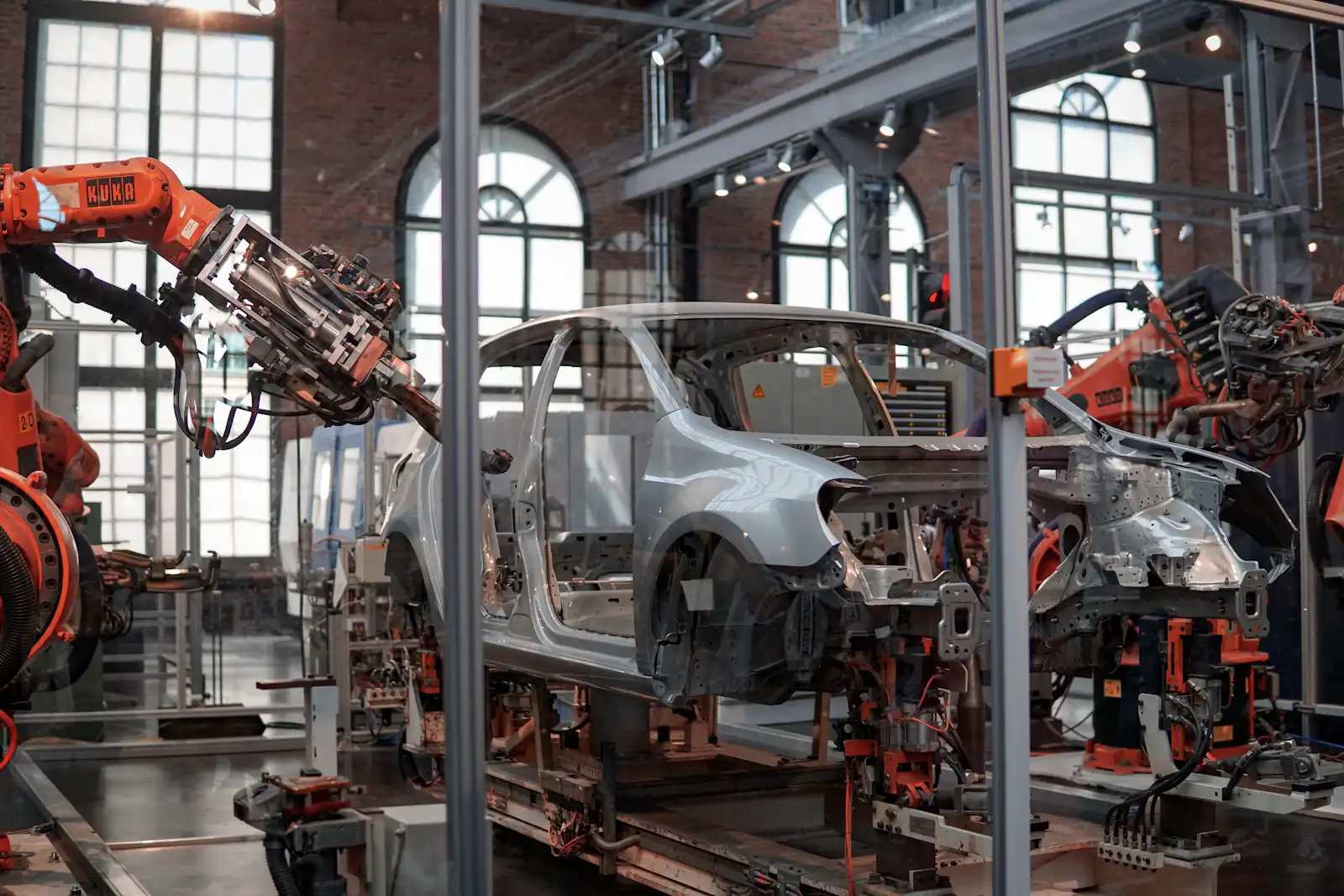Vehicle elevated on an automated assembly line lift inside an automotive plant